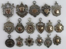 Assortment of seventeen silver fob medals/pendants, all with a full silver hallmark. Gross weight