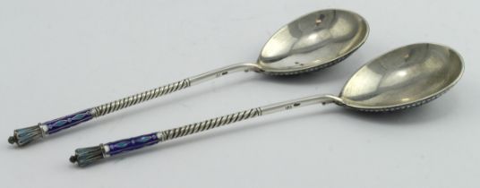 Two Russian silver and enamel spoons, one has some slight enamel damage to the top of its stem, both