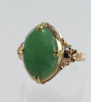 Yellow gold (tests 14ct) jade cocktail ring, cabochon cut jadeite jade measures 15mm x 11mm,