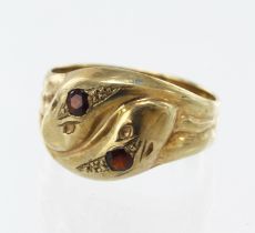9ct yellow gold double serpent head ring, set with two approx. 3mm garnets, head width 14mm,