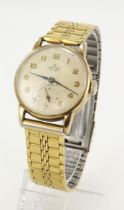 Gents 9ct cased Smiths De Luxe manual wind wristwatch, hallmarked Birmingham 1957. The cream dial