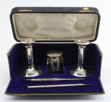 Composite silver pen set comprising two small candlesticks with damaged tops, a silver and glass