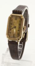 Gents 9ct cased Rolex manual wind wristwatch. The gilt guilloche dial with black Arabic numerals,