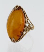 Yellow gold (tests 14ct) amber dress ring, amber measures 25mm x 13mm, finger size N/O, weight 5g.