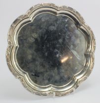 Silver salver raised on three feet, hallmarked 'MH&CoLd, Sheffield 1912', diameter 26.5cm approx.,