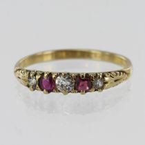 Yellow gold (tests 18ct) diamond and ruby boated shaped ring, three graduating old cut diamonds