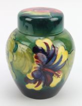 Moorcroft green 'Hibiscus' pattern ginger jar, makers marks and paper labels to underside of both