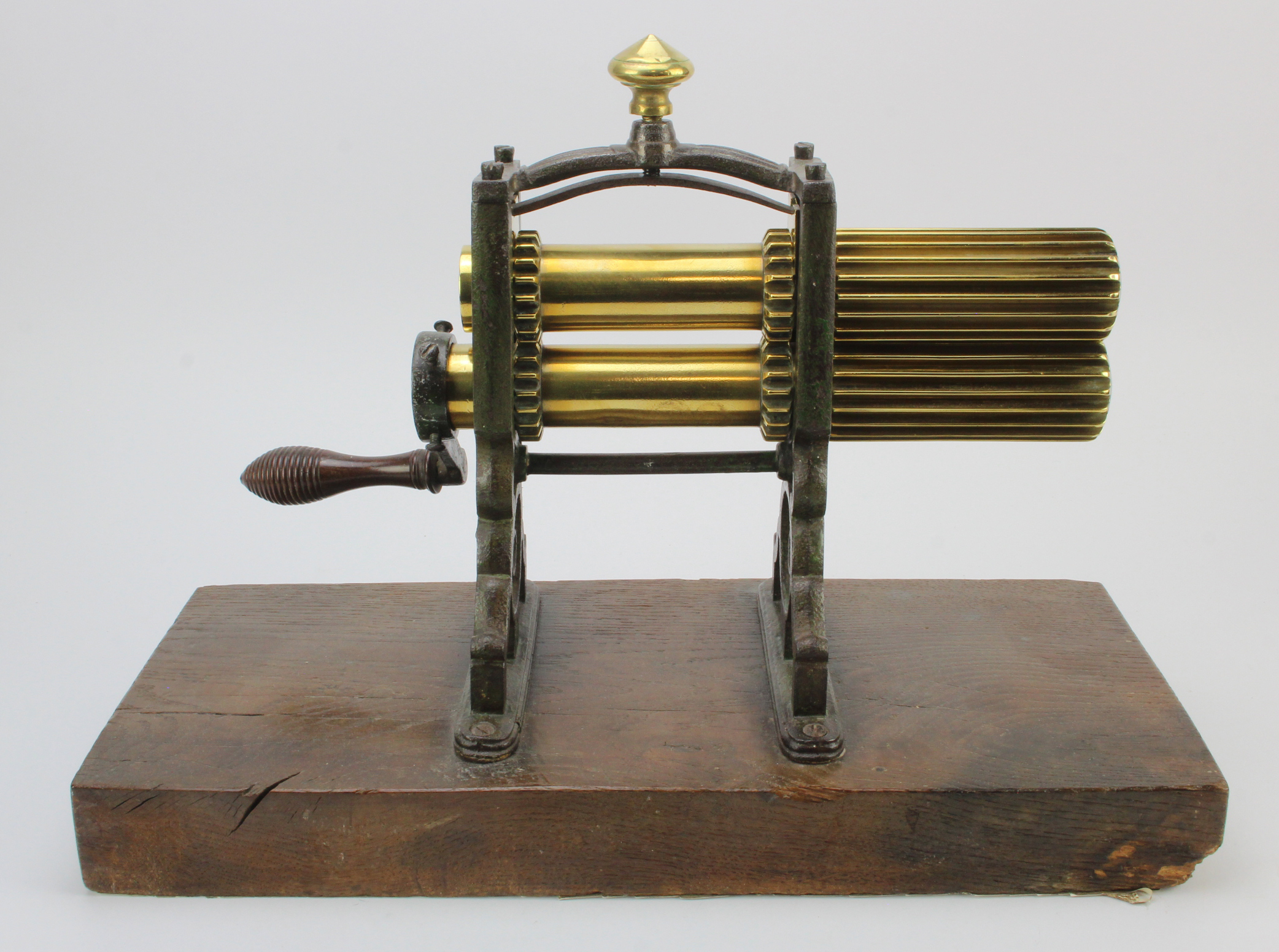 Cast iron and brass crimping machine, circa 19th Century, mounted on a contemporary wooden base,