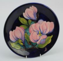 Moorcroft 'Magnolia' pattern plate, makers marks to reverse, diameter 26cm approx.