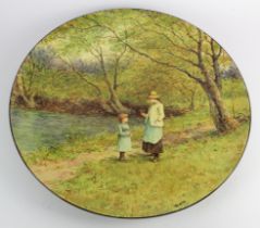 Linnie Watt. Large charger by Doulton Lambeth depicting two sisters stood next to a river surrounded
