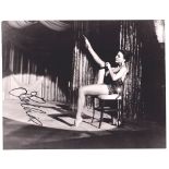 Cinema autograph, Joan Collins, a signed 8" x 10" photograph full length putting on black