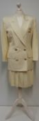 Christian Dior, a cream 2 piece jacket with pleated skirt and 'gold' Dior breast pocket