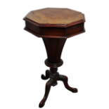 A Victorian walnut octagonal sewing table - the hinged top opening to reveal a fitted interior on