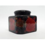 A Moorcroft inkwell - lidded, square with canted corners decorated in pomegranate pattern, width 8cm