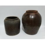 A large stoneware storage jar - treacle glaze, height 43cm, together with a smaller cylindrical jar,
