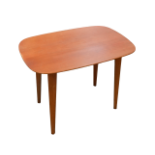 A post war coffee table - the rectangular top with rounded corners on square tapering legs, 66cm x