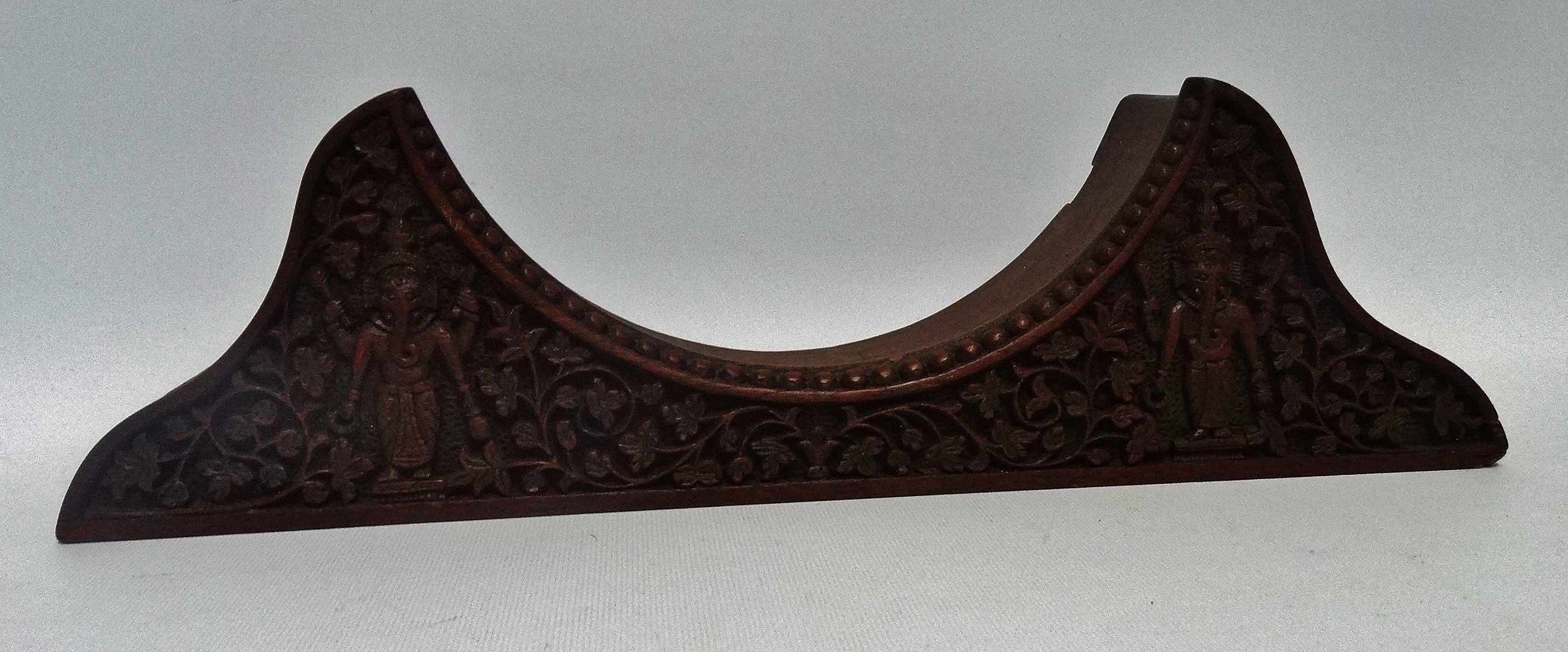 A late 19th/early 20th century carved hardwood clock stand - carved with foliage, width 41cm