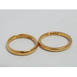 A 22ct yellow gold wedding band - weight 3g, ring size M, together with another 22ct yellow gold