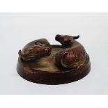 An oriental bronze paperweight - modelled with two recumbent oxen on a circular base, diam 6cm