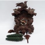 A mid 20th Century Blackforest cuckoo clock - with green painted pinecone weights, height 39cm