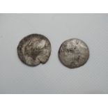 Two silver coloured Roman coins.