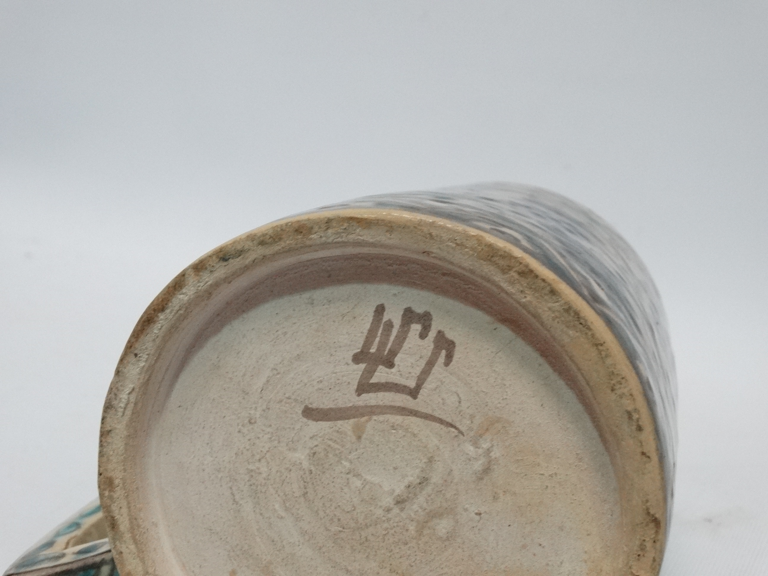 An Iznic glazed mug - decorated with vines within a geometric border, height 15cm. - Image 3 of 3