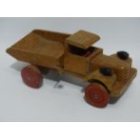 An early 20th century tin plate clockwork saloon car - together with a Chad Valley wooden pull along