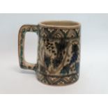 An Iznic glazed mug - decorated with vines within a geometric border, height 15cm.