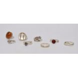 A silver ring - cabochon set with amber, together with six further silver rings, weight 27g, (7).