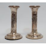 A pair of silver candlesticks - of columnar form with harebell swags, Chester 1912, sponsor mark for