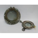 A 20th Century brass porthole - flange diameter 32cm, aperture 21cm, together with another