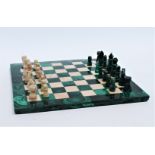 A 20th century malachite and white marble chess board - together with matching chess pieces, chess