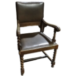 A 17th century style oak open armchair - with upholstered seat and back and spiral turned legs