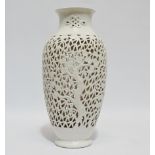 A blanc de chine reticulated vase - of baluster form, decorated with cherry blossom, height 36cm.