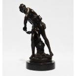 After Bernini - a 19th century cast and patinated bronze study of David, standing taking aim with