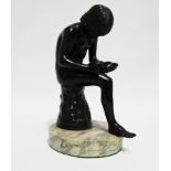 After the Antique - a 19th century cast and patinated bronze study of Spinario, seated on a tree