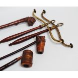 A pair of Edwardian coat hangers - brass with mahogany handles, together with two pipes and a riding