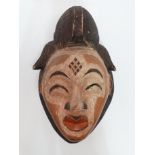 An African wall mask - polychrome decorated, height 37cm.