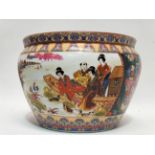 A 20th century Chinese fish bowl - decorated with vignettes of figures beside a lake, height 23cm.