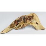 A jaw bone - hieroglyphically decorated with African beasts, width 34cm.