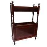 An Edwardian style mahogany book and magazine rack - the book trough with turned supports above a