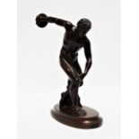 After the Antique - a 19th century Grand Tour patinated bronze of a discus thrower, the figure of