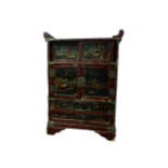 A late 19th century Japanese red lacquer table cabinet - with an arrangement of panelled doors,