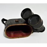 A pair of early 20th century field glasses - brass with black leather mounts, in leather case.