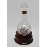 A silver mounted cut glass port decanter - Edinburgh 1997, of globe form with a turned wooden base,