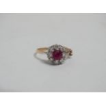 A pink sapphire and diamond dress ring - the central octagonal cut stone within and band of