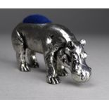 A white metal pin cushion - modelled as a hippopotamus, length 5.8cm.