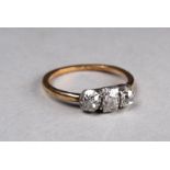 A three stone diamond ring - set in a yellow metal band, possibly 9ct gold, size L, weight 2g,