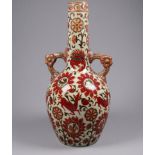 An early 20th century Zsolnay vase - of Persian pattern with twin handles and decorated with