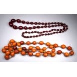A uniform strand of butterscotch amber beads - together with a graduated string of beads.